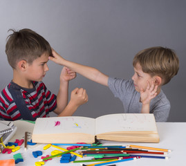 boys quarrelling while learning