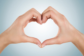 Close up of female hands form heart shape