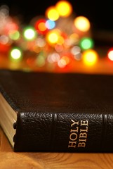 Holiday background with blurred lights and Bible