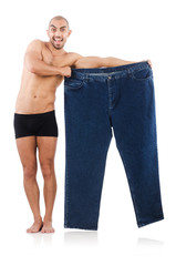 Man in dieting concept with oversized jeans
