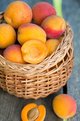apricots in a basket on wooden background
