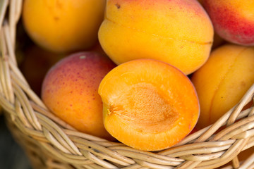 Naklejka na ściany i meble apricots in a basket on wooden background