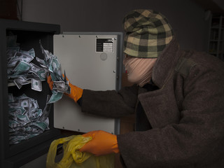 A thief steals money from the safe