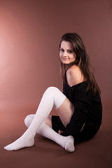 Beautiful girl on brown background studio shot