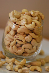 cashewnuts in a glass on a white plate