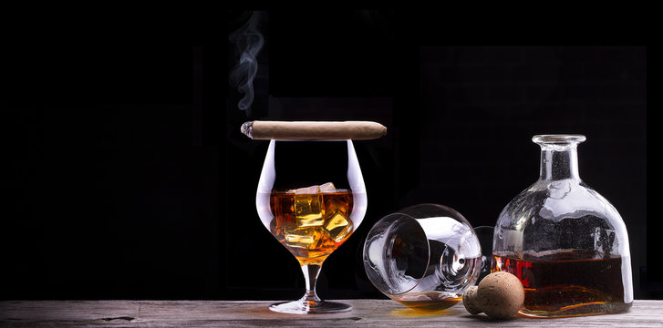 Cognac and Cigar on black with vintage table
