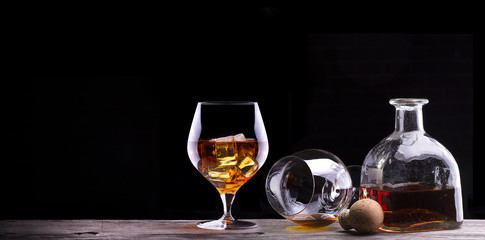 Obraz na płótnie Canvas Cognac or brandy on a wooden table