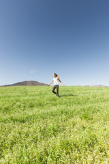 Teenage girl running in meadow