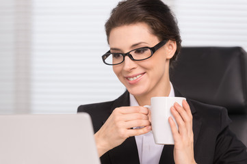 Businesswoman drinking coffee. Confident middle-aged businesswom