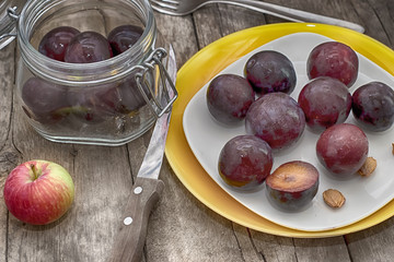 Ripe plums on a wooden background
