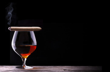 Cognac and Cigar on black with vintage table