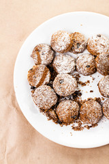 Pile of small cookies on a dish on brown paper parchament