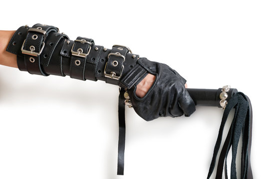 Hand in leather glove with lash and shadow