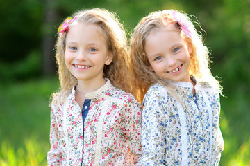 Portrait of two little girls twins - obrazy, fototapety, plakaty