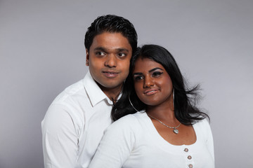 Young romantic indian couple. Wearing white shirt and jeans. Stu