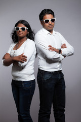 Young hip indian couple. Wearing white shirt and sunglasses. Stu