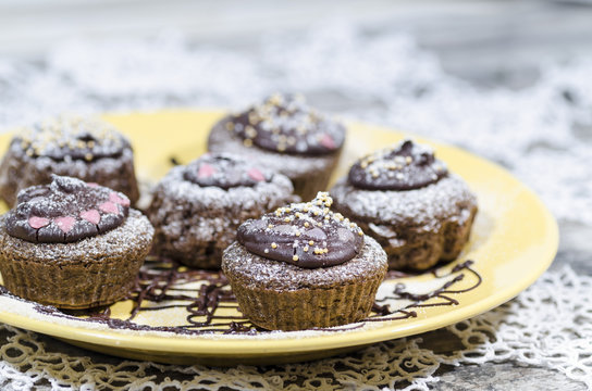 Diet chocolate cupcakes on yellow plate