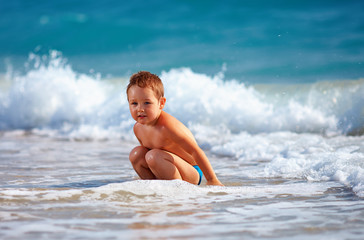 Fototapeta premium happy boy kid having fun in sea water