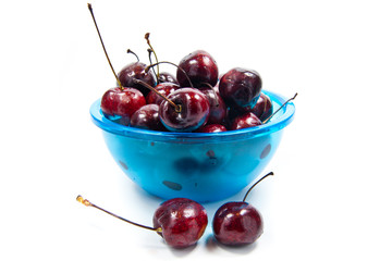Fresh cherries in bowl isolated on white