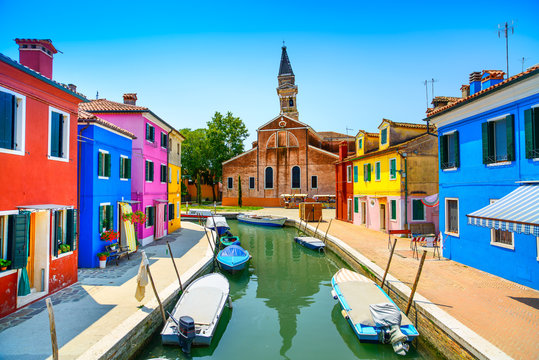 Venice landmark, Burano canal, houses, church and boats, Italy