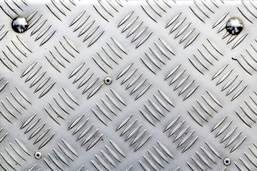 Dotted metal plate. Shiny steel. Metal background.