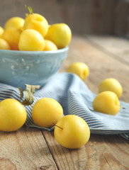 Yellow plums in blue bowl