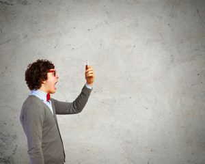 Young man shouting at his mobile phone