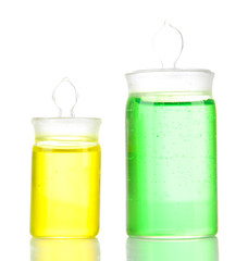 Bottles with colored liquids isolated on white