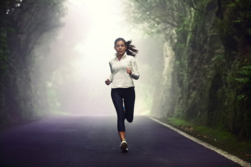 Fototapeta na wymiar Woman running on road