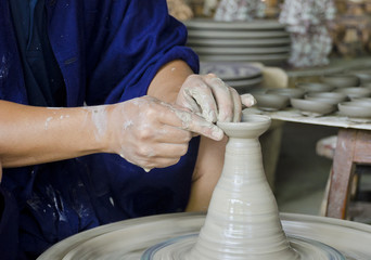 Close up of hands making pottery