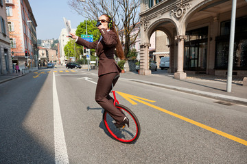 business woman drink a coffee on the unicycle