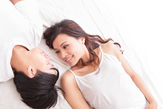 couple happy smile looking to each other in bed