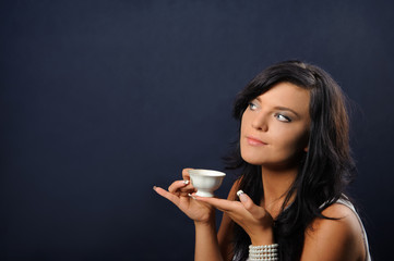 Beautiful woman with a cup of coffee. - obrazy, fototapety, plakaty