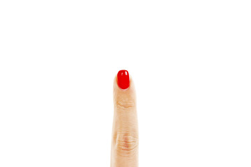 Finger with red manicure on white background