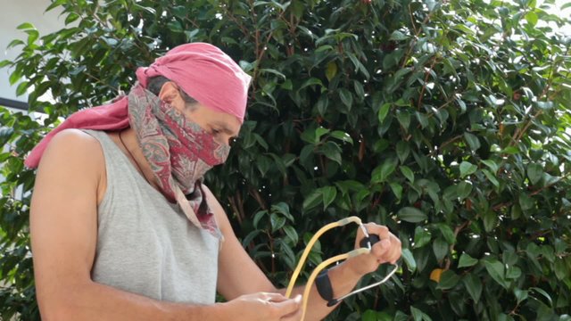 masked man with sling