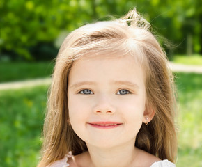 Fototapeta premium Outdoor portrait of adorable smiling little girl