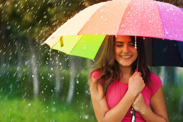 Beautiful woman under rainbow umbrella © gpointstudio