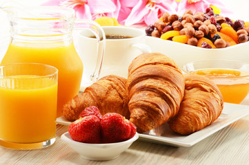 Breakfast with croissants cup of coffee and fruits