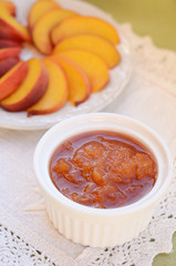 Homemade peach jam in white bowl