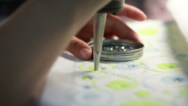 View of sticking sequins on fabric