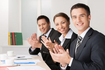 Business conference. Cheerful business people applauding and loo