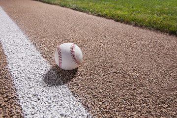 Baseball on a base path under lights at night