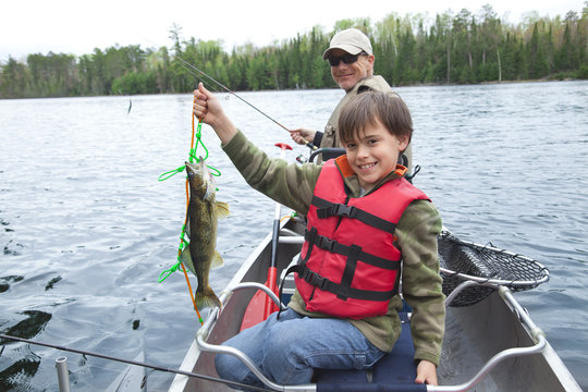 Young fisherman proudly shows first walleye of the day