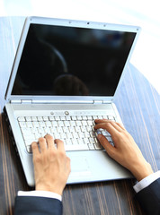 Fototapeta na wymiar Person Typing on a modern laptop in an office