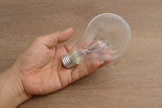 Incandescent  light bulb in hand