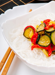 Rice noodles and vegetables on white plate