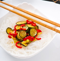 Rice noodles and vegetables on white plate