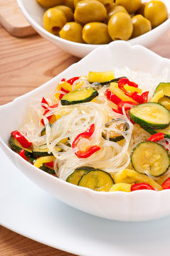 Rice noodles and vegetables on white plate