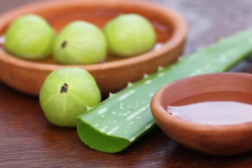 Fresh amla and aloe with small bowls