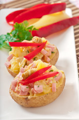 baked potato with sausages and salad